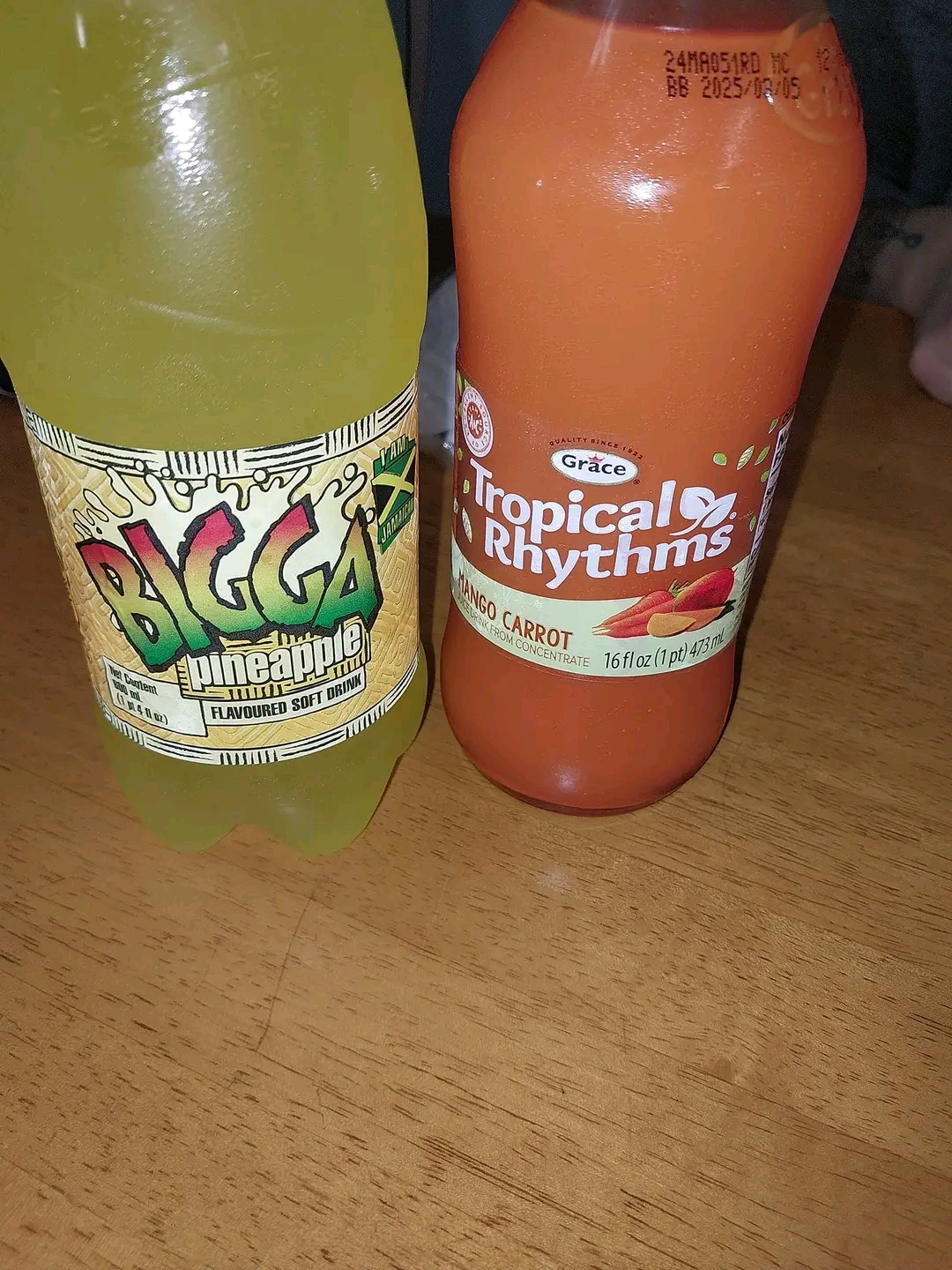 Photo of two bottles from Kool Runnins - Bigga Pineapple soft drink and Tropical Rhythms mango carrot juice | Black Owned Maine Portland African Restaurant