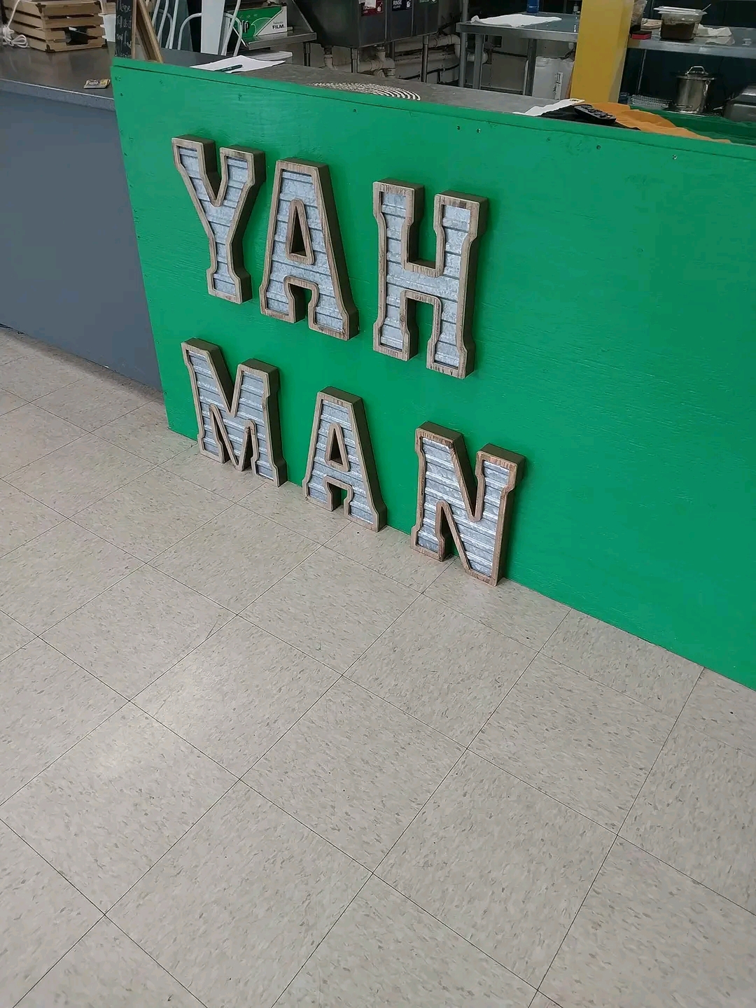 Photo of sign - Yah Man on green background - Kool Runnins | Black Owned Maine Portland