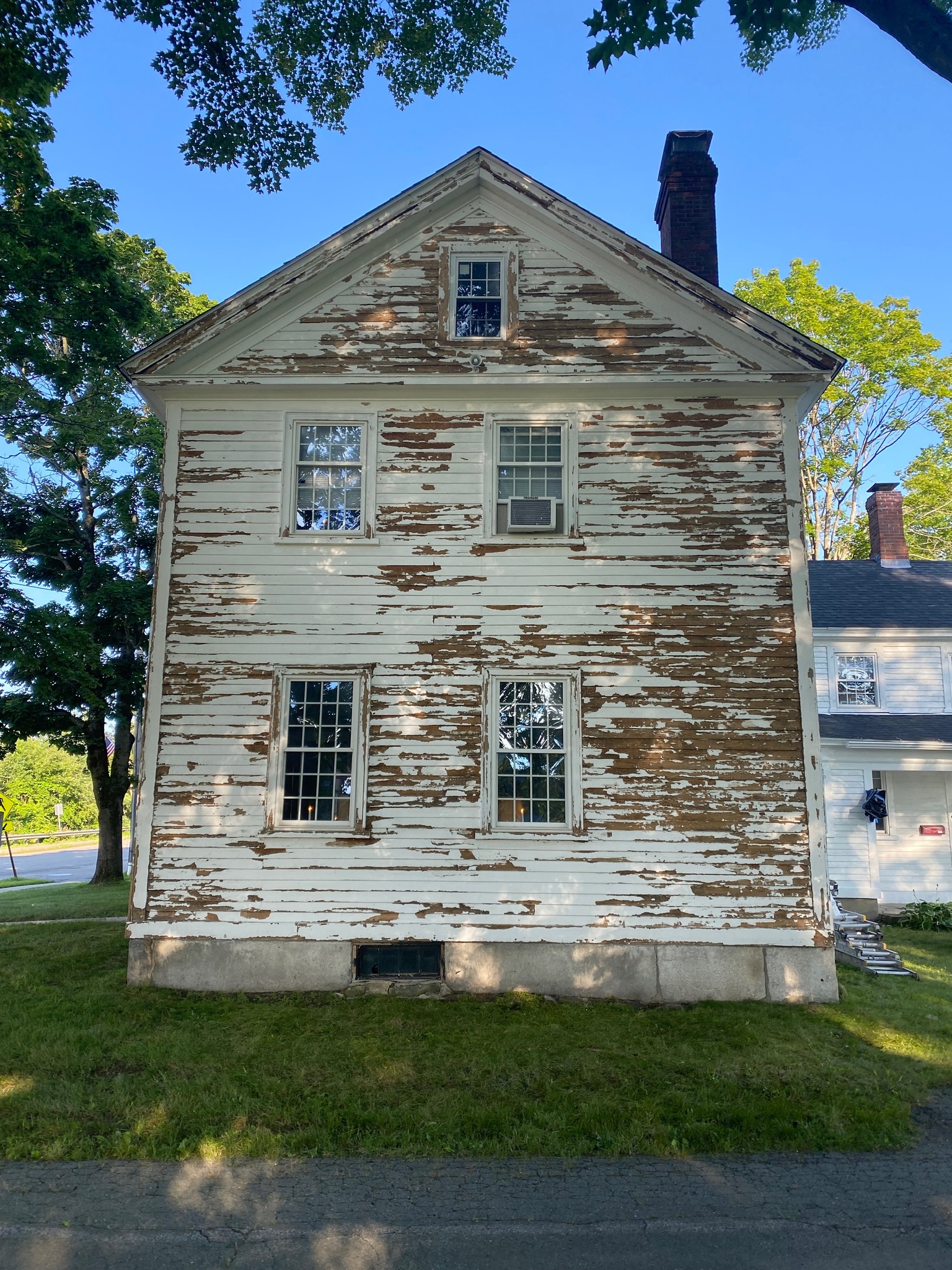 Photo of a white house that has been prepped for painting | Black Owned Maine Portland